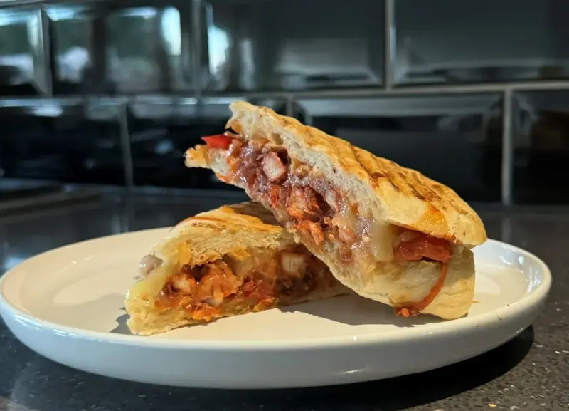 Tandoori Chicken Delight — toasted panini halves on a white plate